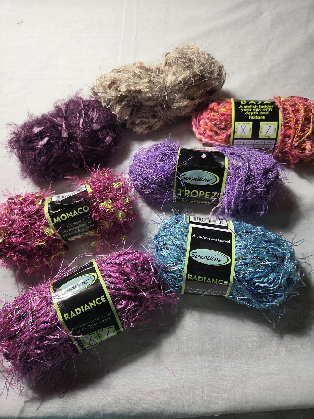 Collection Of Discontinued Novelty Yarns From Jo Ann Fabrics. 7 Bundles